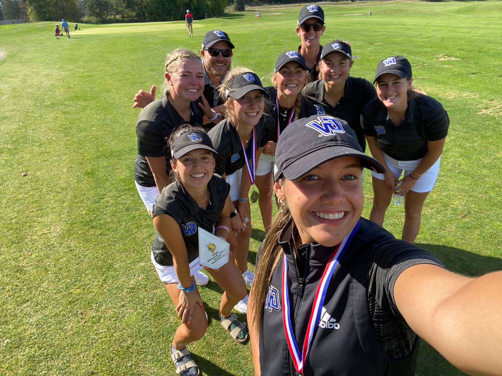 Women's golf team selfie on the course